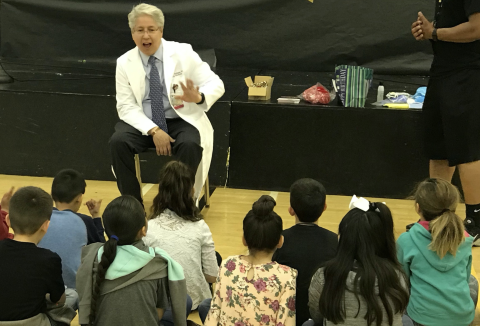 Dr. Salinas talking to a group of elementary students at Doctors Day